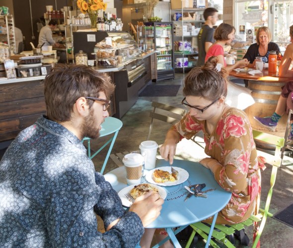 various customers seated at tables enjoy breakfast inside Noisette Pastry Kitchen in Eugene, Oregon, picture