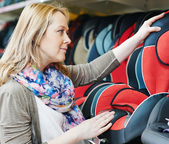 A pregnant woman shops for a child car seat
