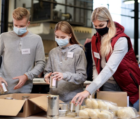 A family volunteers at a food bank together.