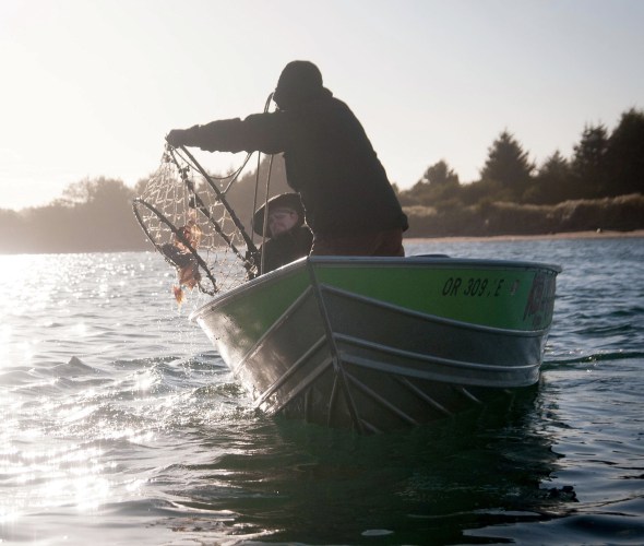 Fisherman checking crab pots off Oregon coast.