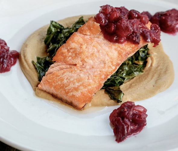 plate of pan-roasted salmon with cranberry compote, wilted greens on squash puree at Indian Pueblo Kitchen in the Pueblo Cultural Center, Albuquerque, New Mexico