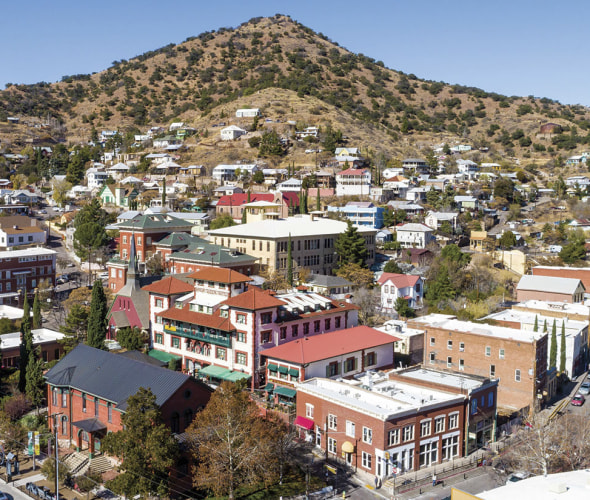 Elevated view across downtown Bisbee, Arizona, on a clear, cloudless day.
