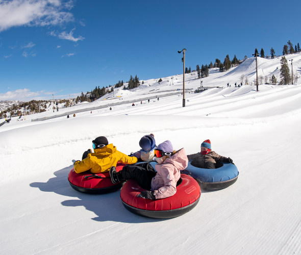 Riders slide down the large tubing hill at Woodward Park City in Utah.