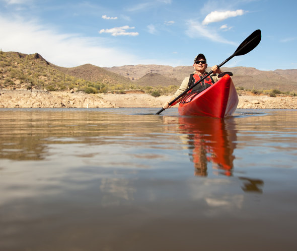 A man kayaks on a lake in Arizona.