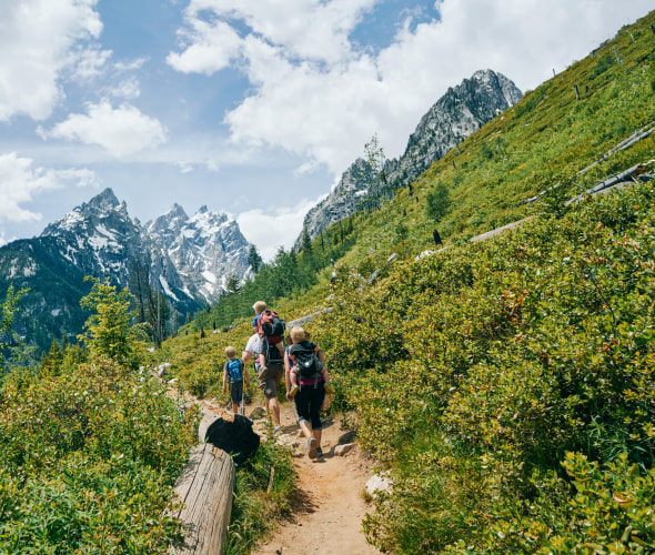 A family hike on a trail in Grand Teton National Park.