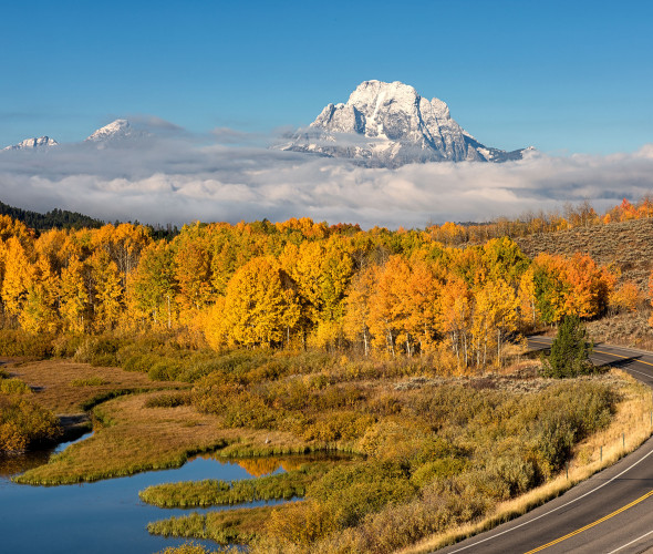 Mt. Moran overlooks a winding road in Wyoming's Teton National Park.