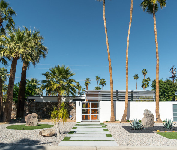 A mid-century modern home in Palm Springs, California on a sunny day.