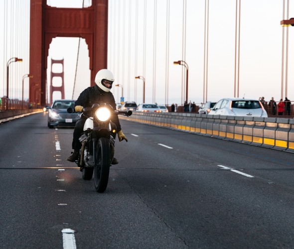 A motorcycle rider changes lanes on the Golden Gate Bridge in San Francisco.