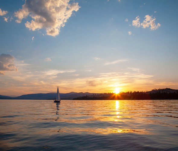 A sailboat at sunrise on Flathead Lake near Kalispell, MT. 