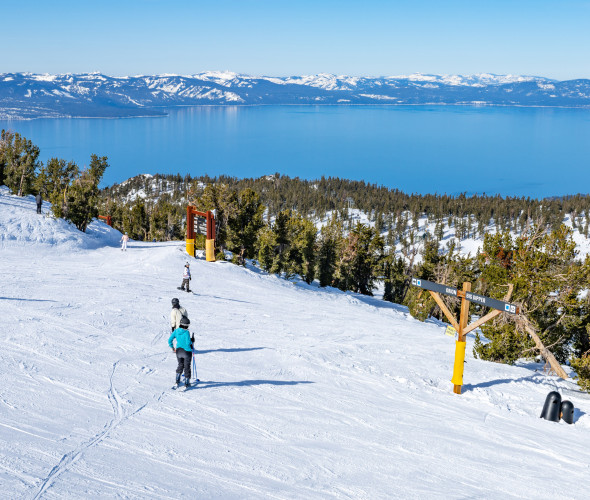Skiers and snowboarders at the top of Big Dipper at Heavenly Mountain Resort in Tahoe, Nevada.
