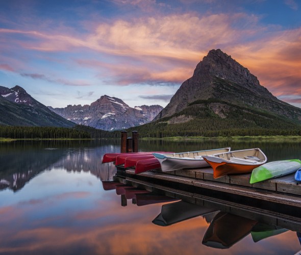 Canoes and row boats on the dock at Swiftcurrent Lake in Glacier National Park, Montana.