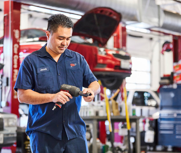 A mechanic prepares a tool in a AAA repair shop
