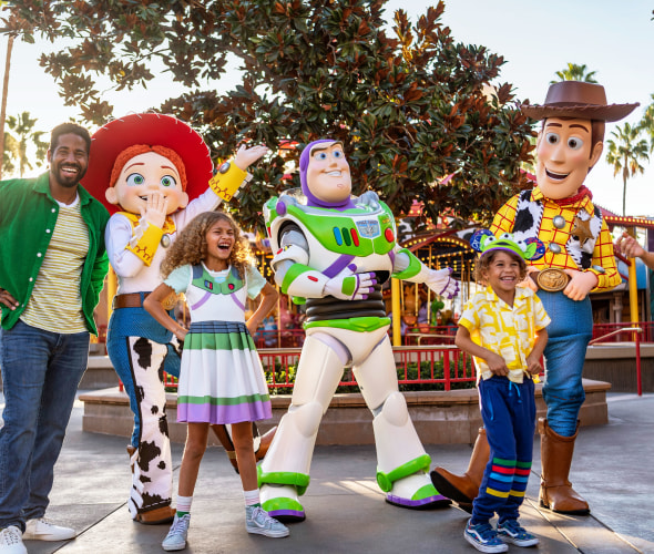 A family poses with characters from Toy Story at Disneyland Resort.