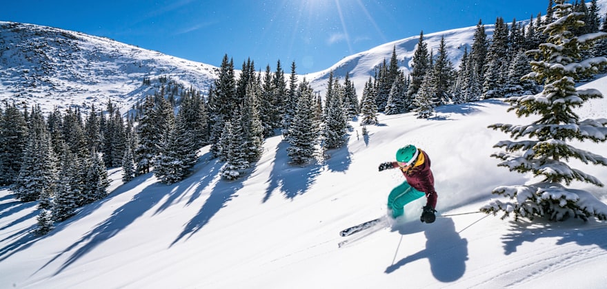 A woman skis down a run at Winter Park Resort in Colorado, photo