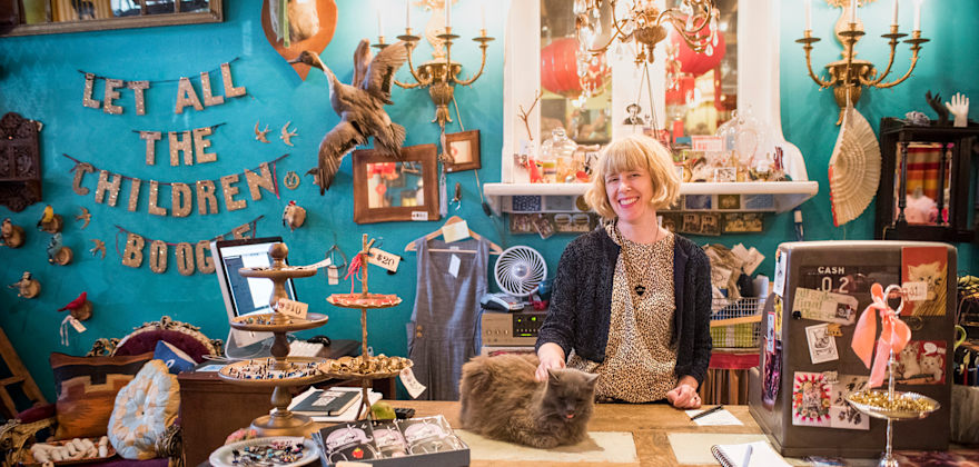 a clerk pets the store cat at curiosity-filled Flutter