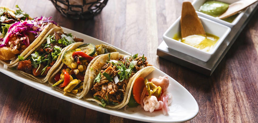 Platter of tacos with salsa at Tacolicious in California