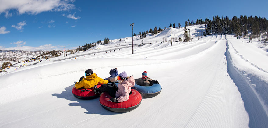 Riders slide down the large tubing hill at Woodward Park City in Utah.