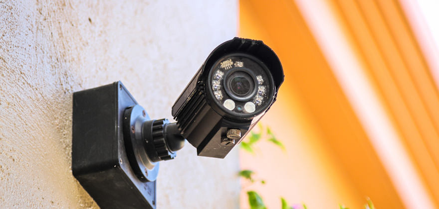 An outdoor camera installed on an exterior house wall.