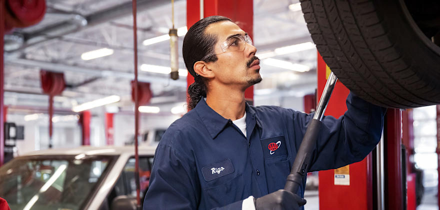 A technician removes a tire inside a AAA Auto Repair Center.