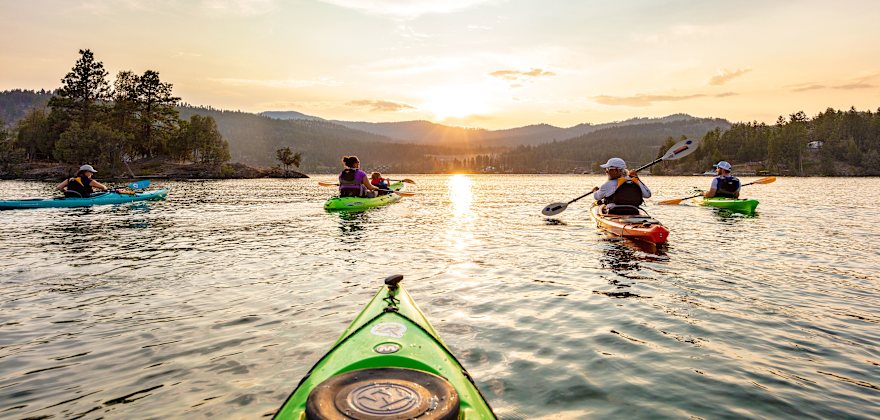 A family kayaks on Flathead Lake in Montana.