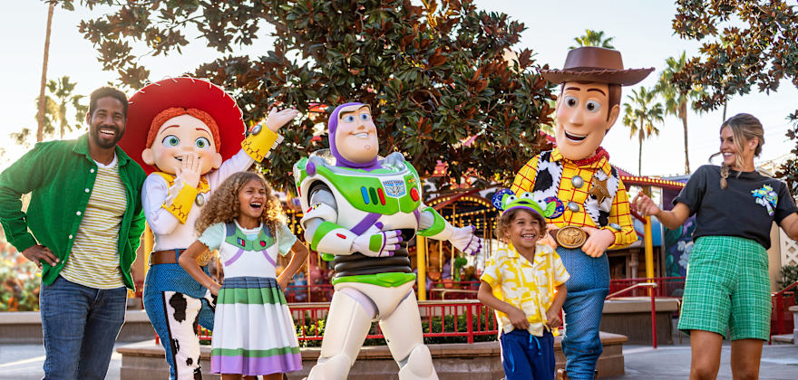 A family poses with characters from Toy Story at Disneyland Resort.