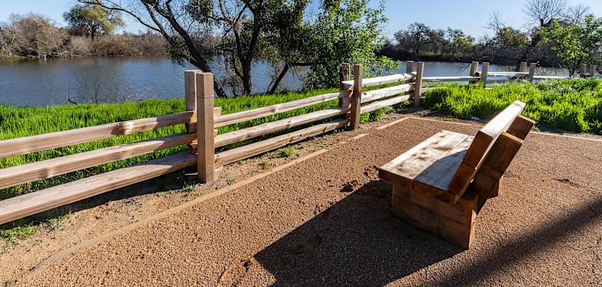 A bench overlooks the pond at Dos Rios State Park in California.