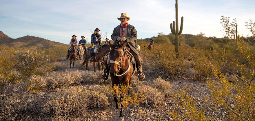 A group of riders meander through the desert at Kay El Bar Guest Ranch in Arizona.