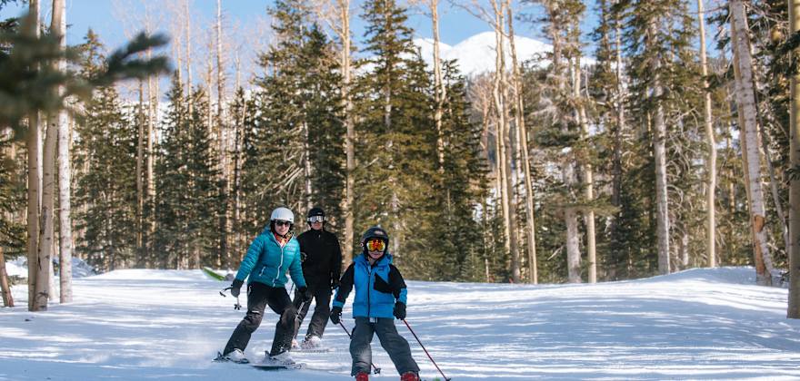A family skis at Arizona Snowbowl in Flagstaff, Arizona.