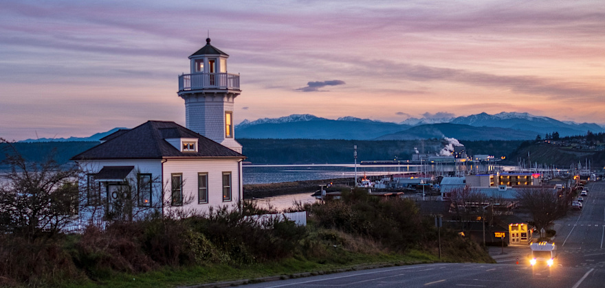 Historic white lighthouse in Port Townsend, Washington at dusk.