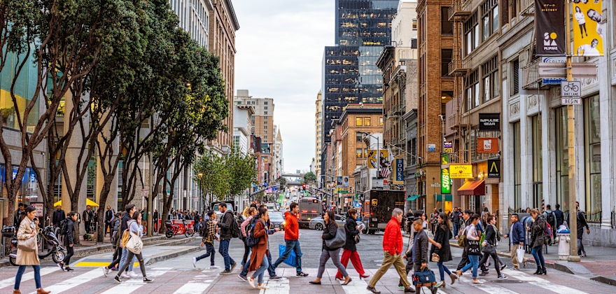 Pedestrians in a busy crosswalk in downtown San Francisco.