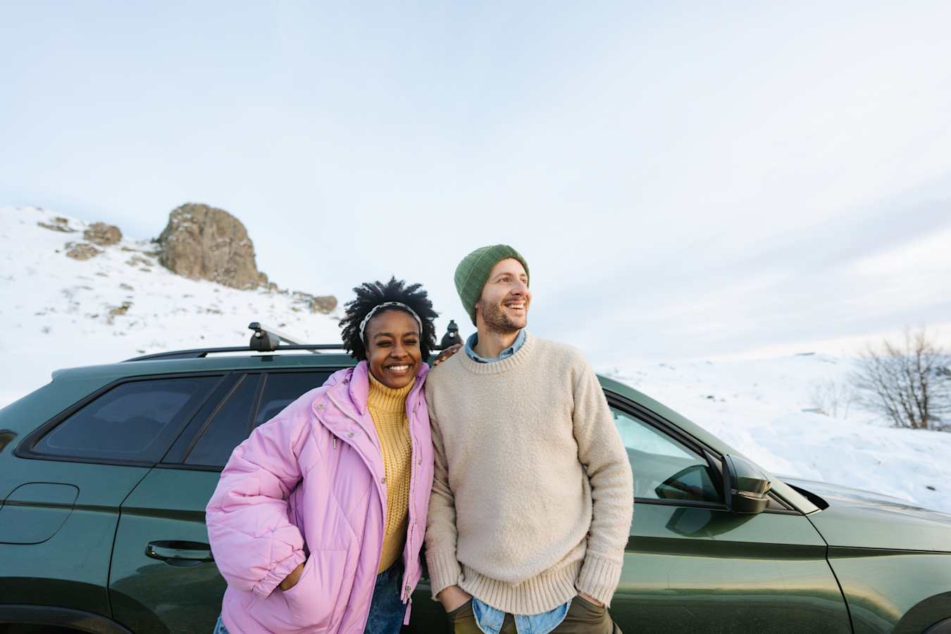 AAA Members and their sons sitting on a dock at a lake in the summer.