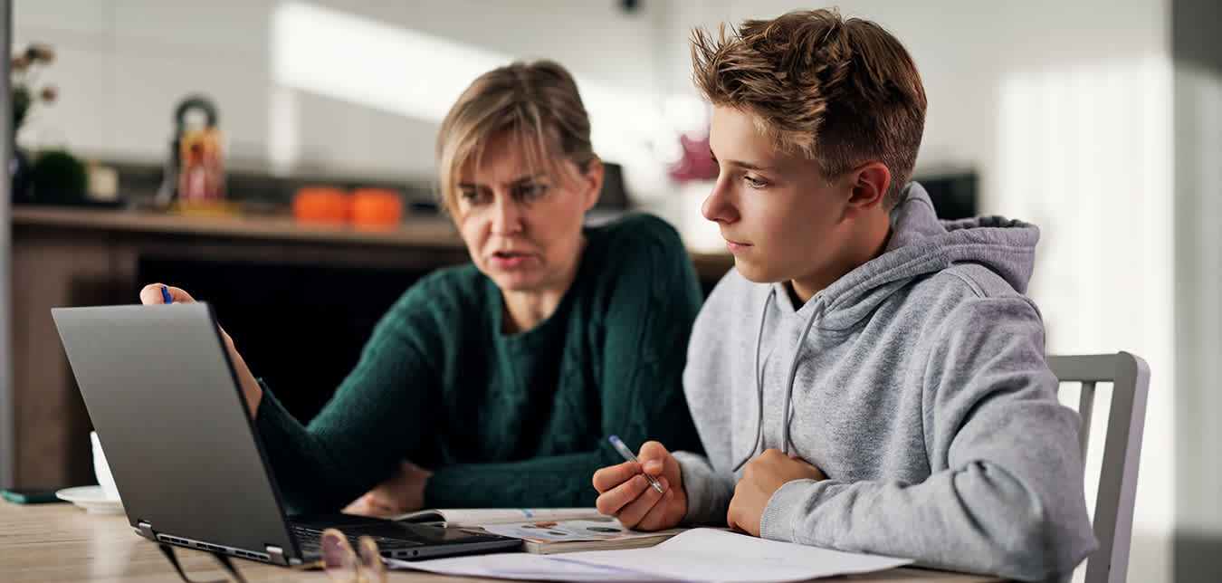 teen works on how to drive online on a laptop