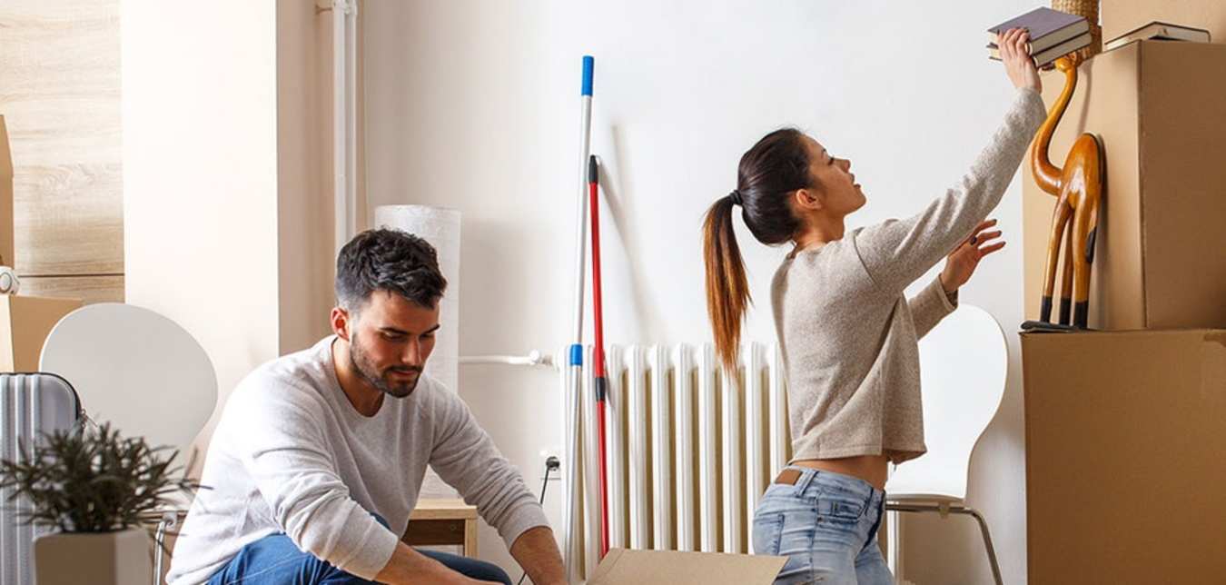 couple unpacking boxes in AAA Renters Insurance covered apartment