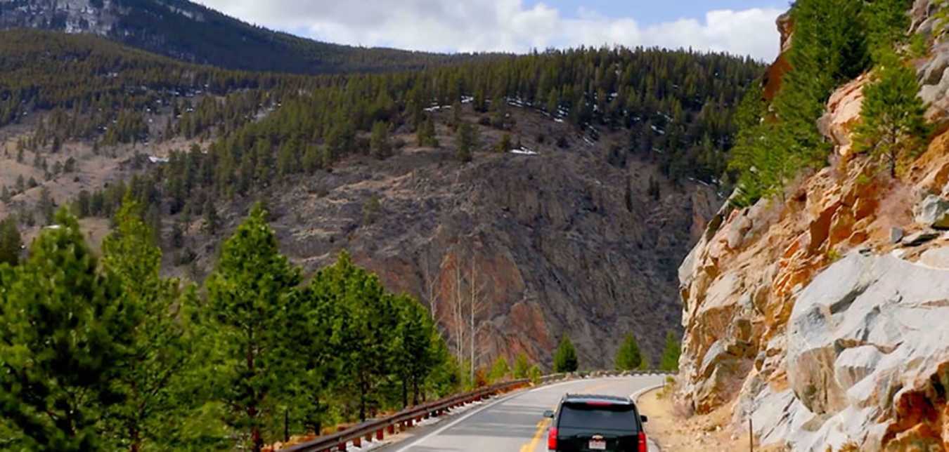 an SUV on a scenic highway from AAA's Journeys TV ad