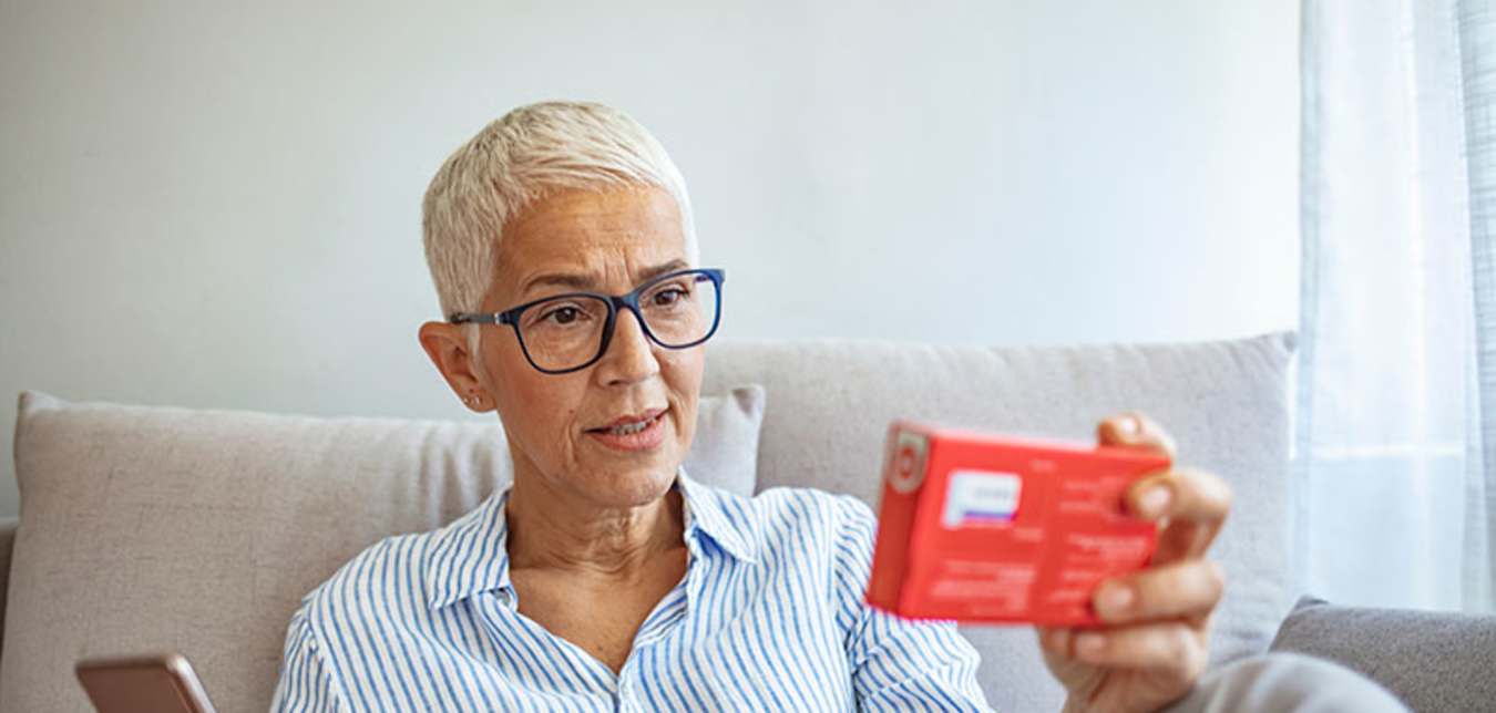 a woman looks up her medication on AAA's Roadwise RX