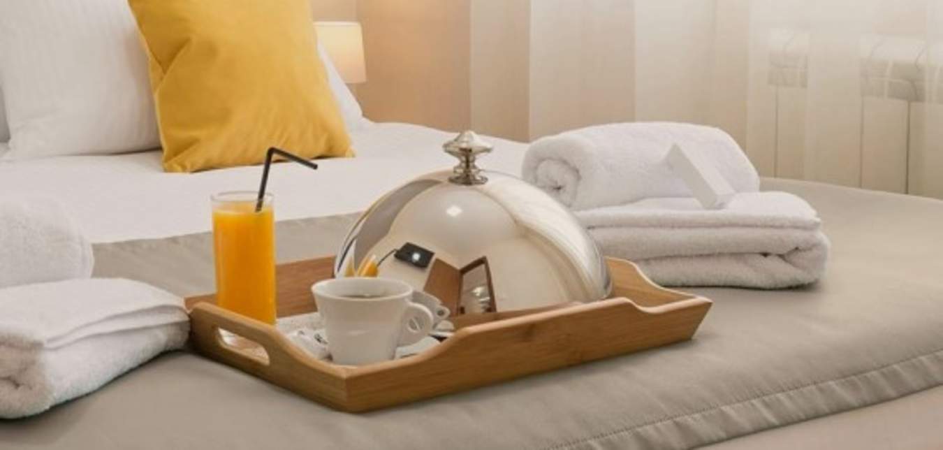 Hotel bed with breakfast tray