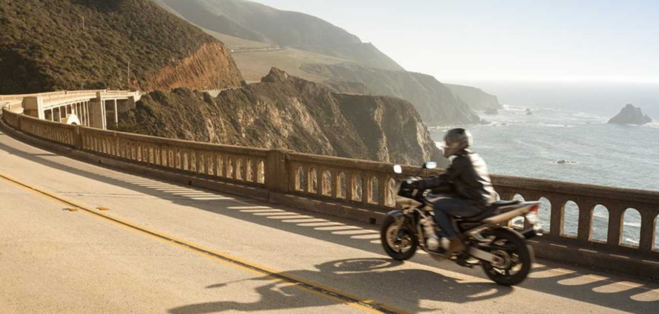 Man covered by AAA motorcycle insurance rides down the pacific coast highway