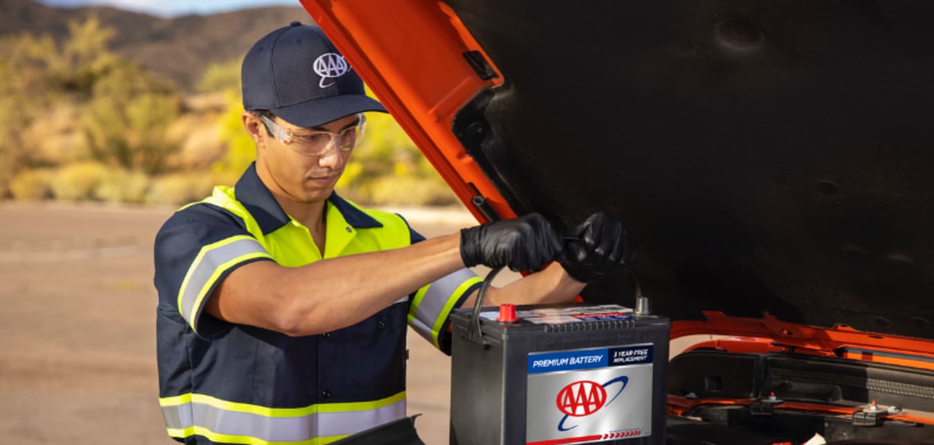 A Member of AAA has her battery replaced by a tow truck driver