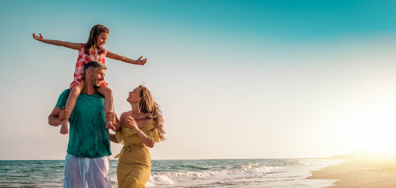 a AAA family walking on beach 