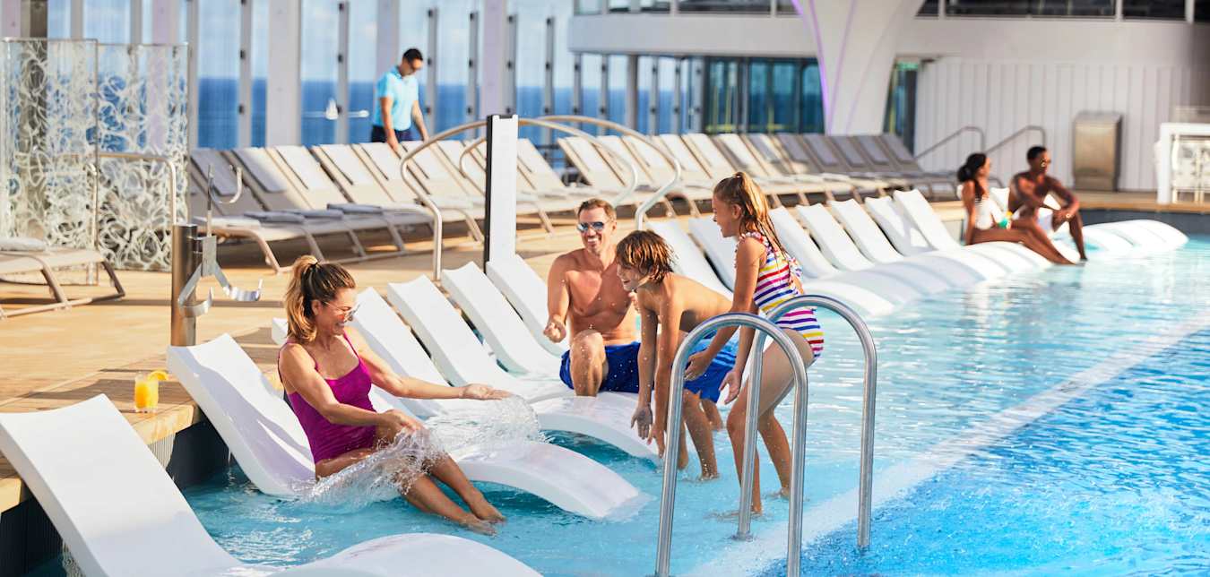 family by a celebrity cruise ship pool