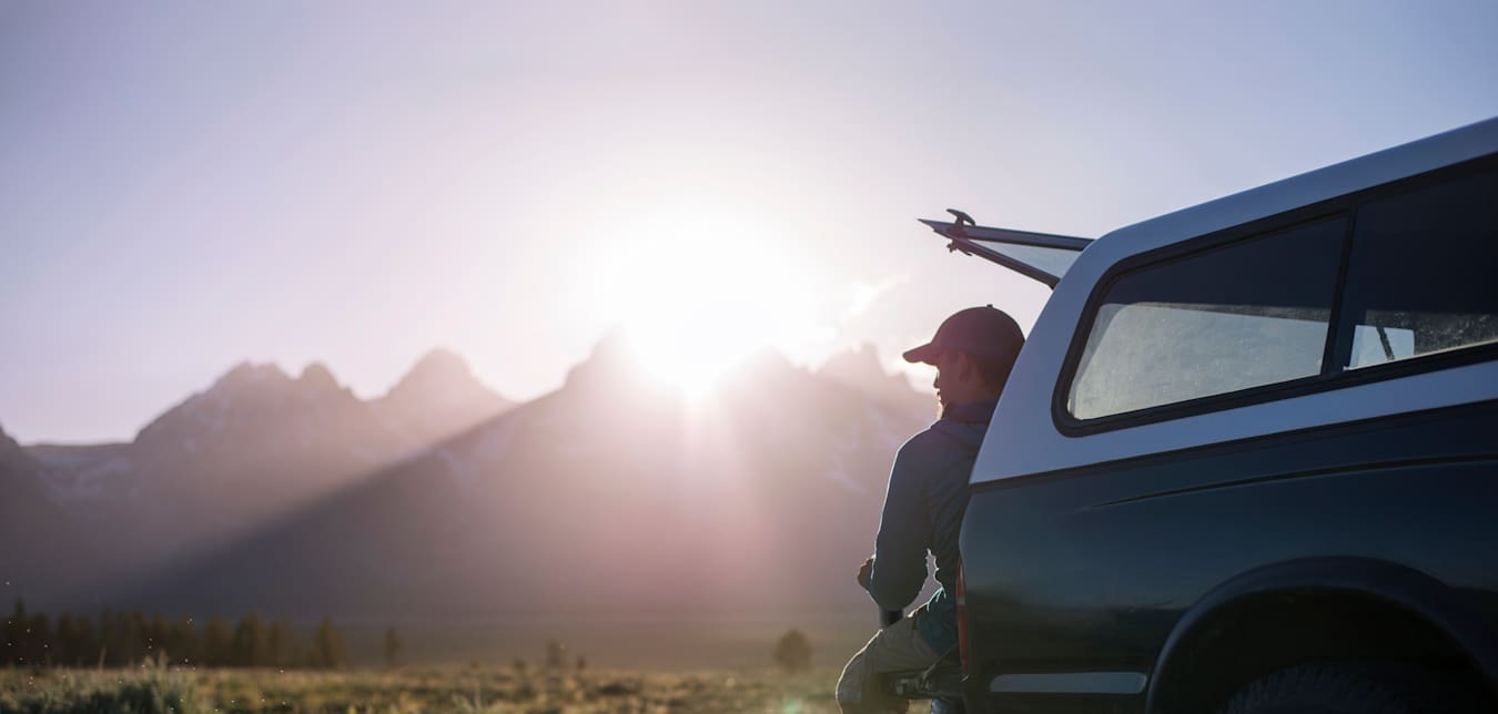 Man sitting in back of truck