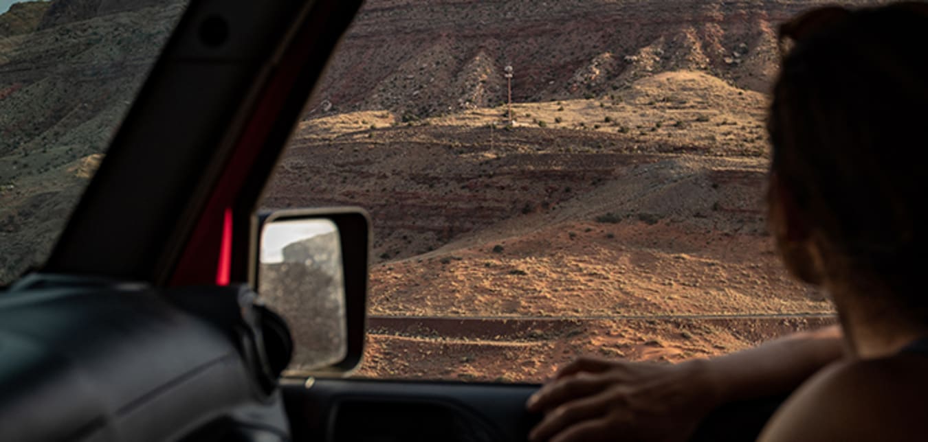 Woman looking our of truck window at Utah scenery