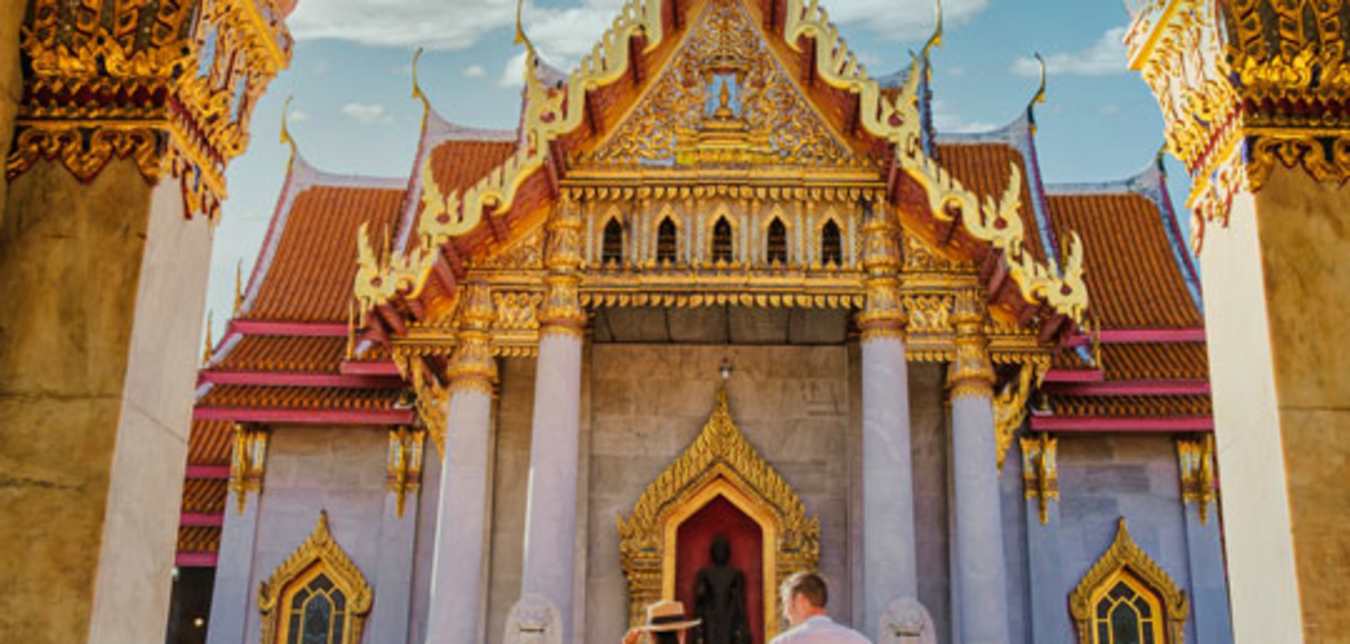 couple in front of temple in thailand