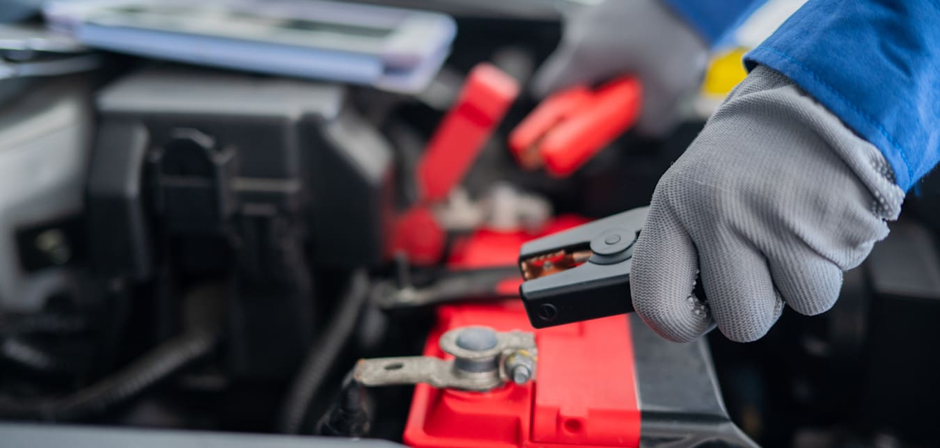 a battery is jump-started with negative and positive cables