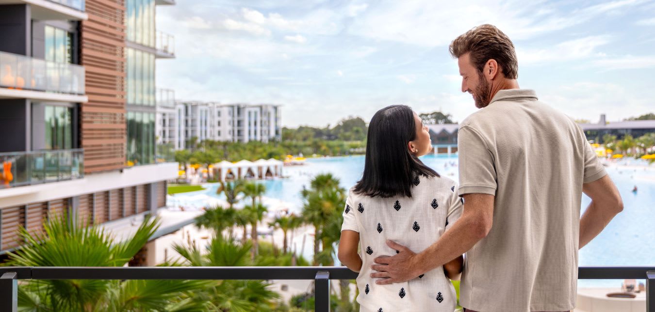 couple looking out hotel balcony