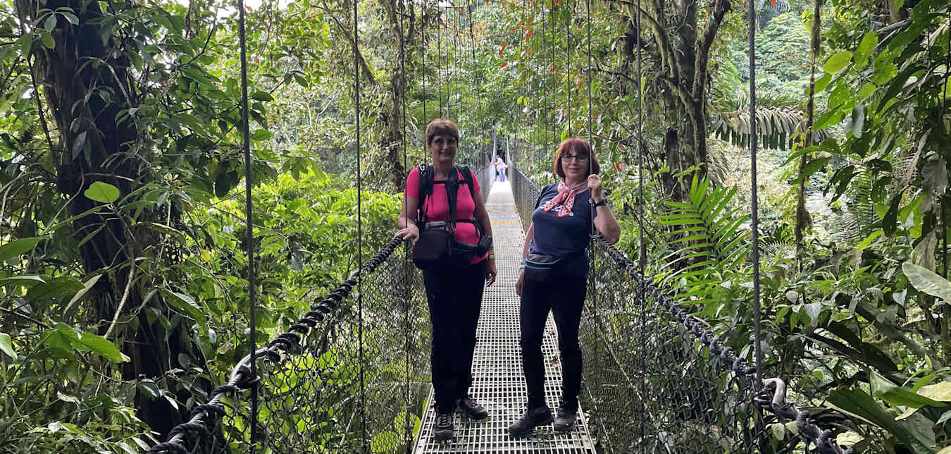 women on a bridge in costa rica