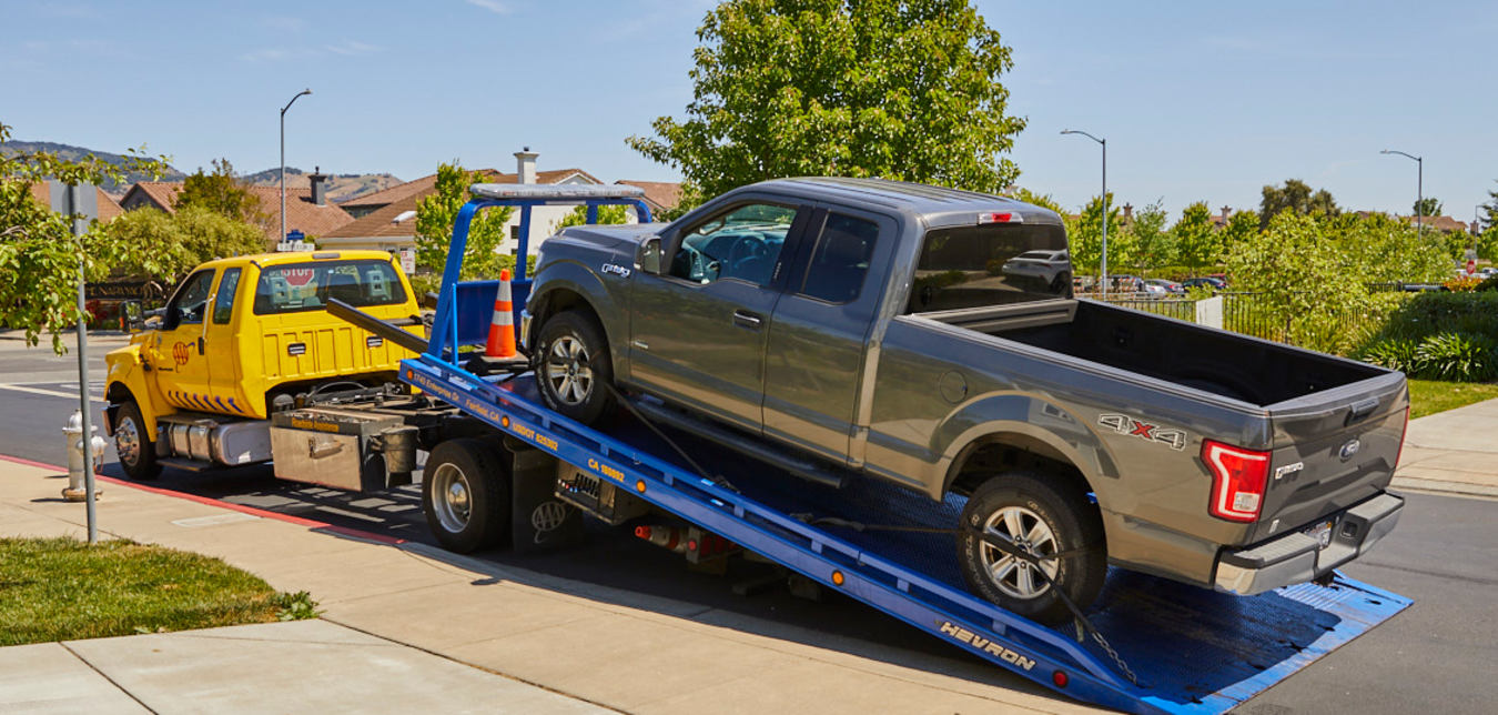 AAA tow truck picks up a broken down truck.