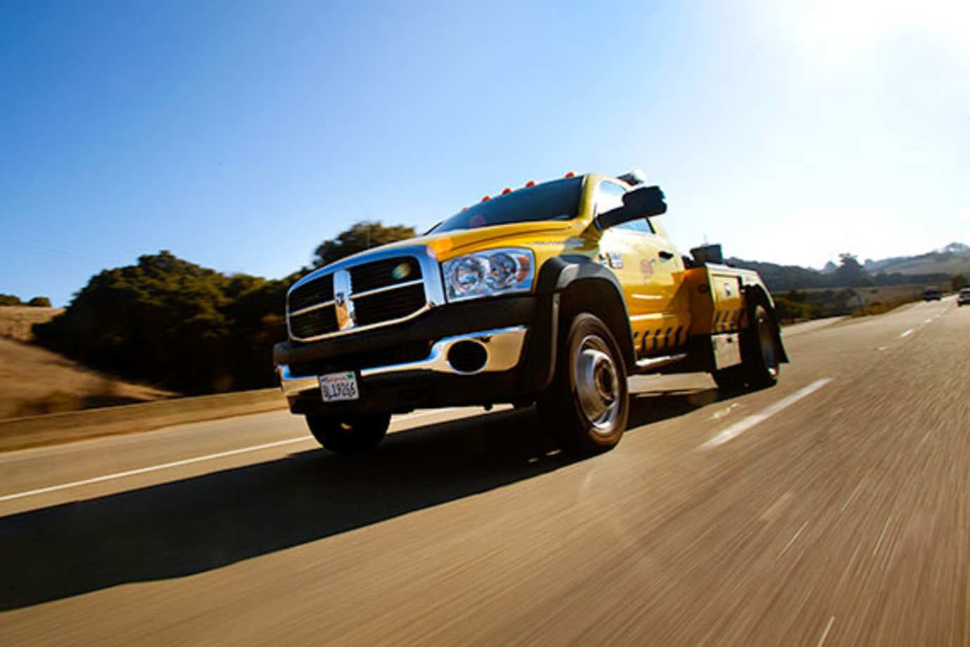 AAA tow truck driving to a roadside service call