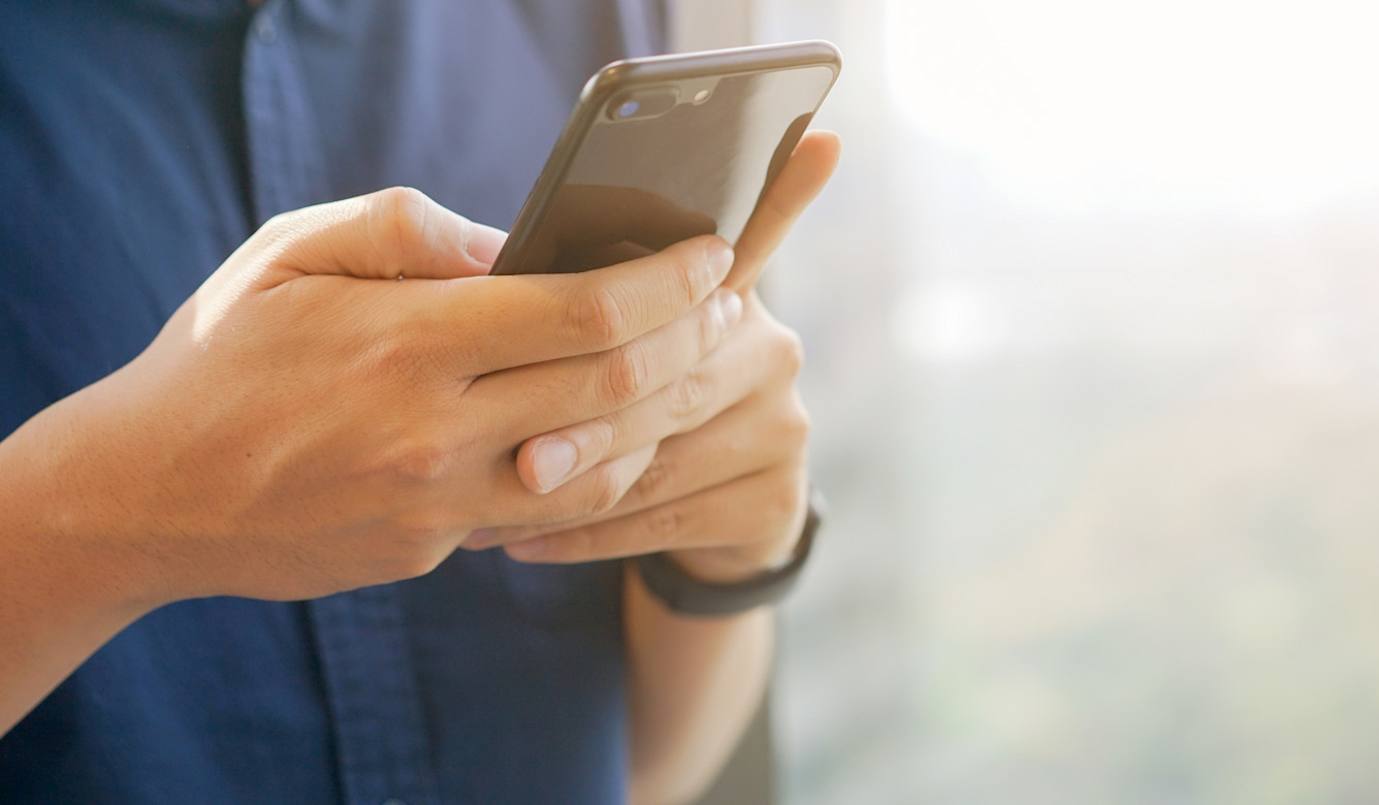 Person holding smart phone