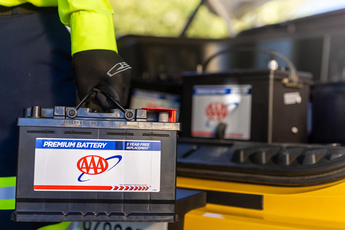 roadside technician delivers AAA battery